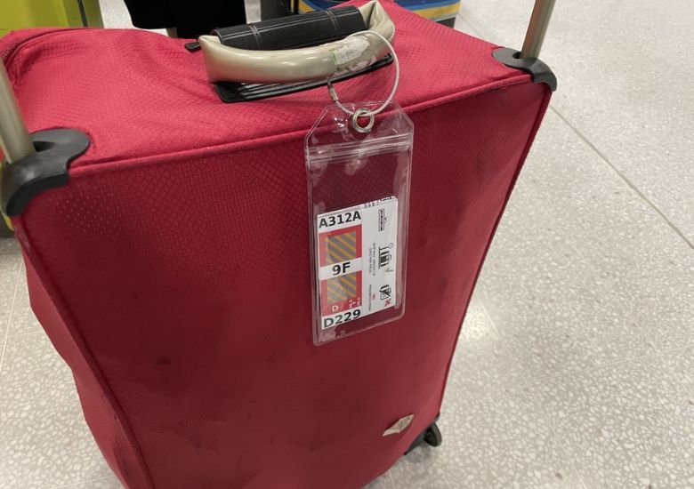 Red suitcase with a cruise luggage tag