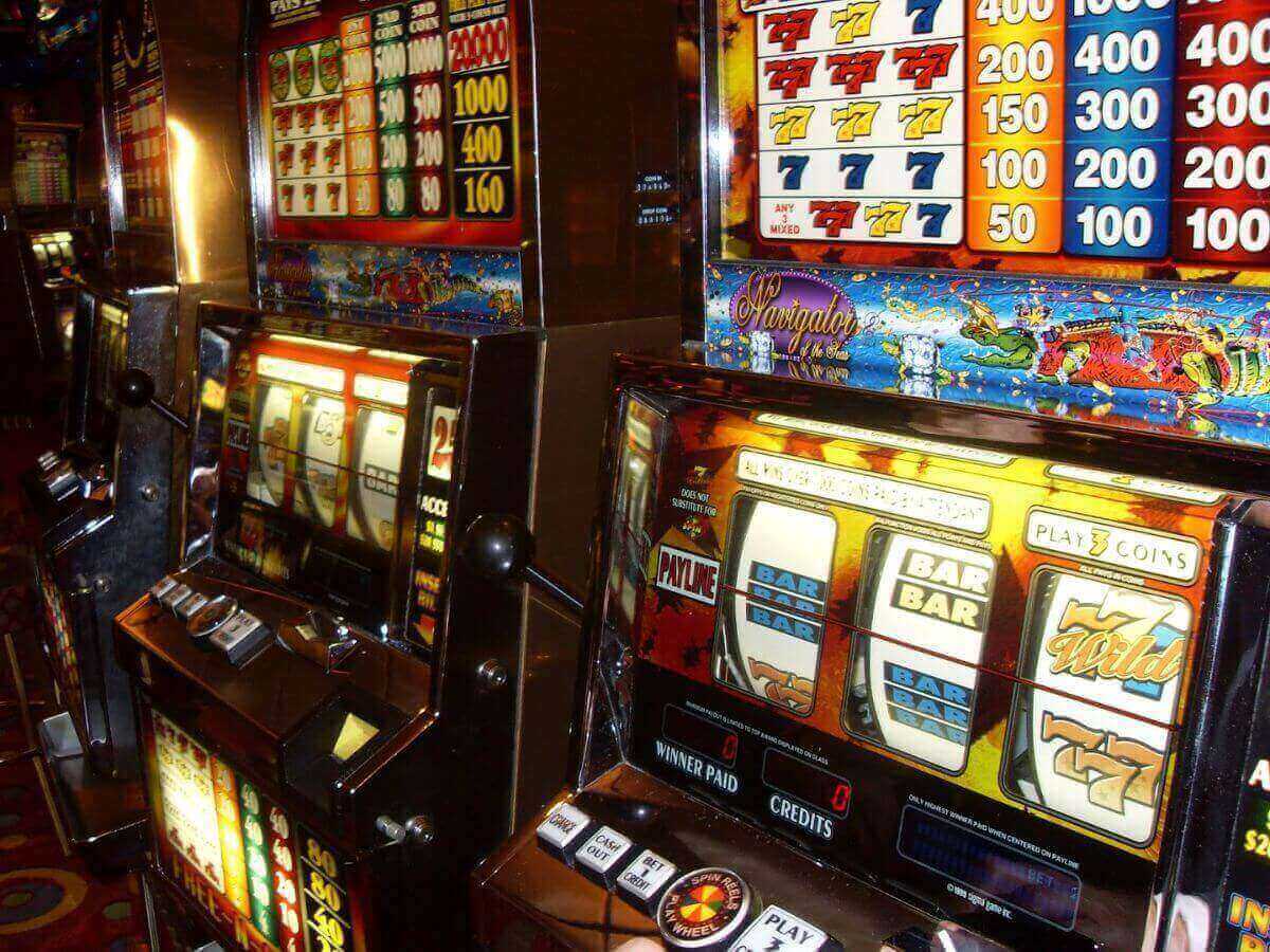 A vibrant array of slot machines in the casino aboard a Royal Caribbean cruise ship, with colorful displays and the chance for games and entertainment, contributing to the lively atmosphere of the ship's onboard activities.