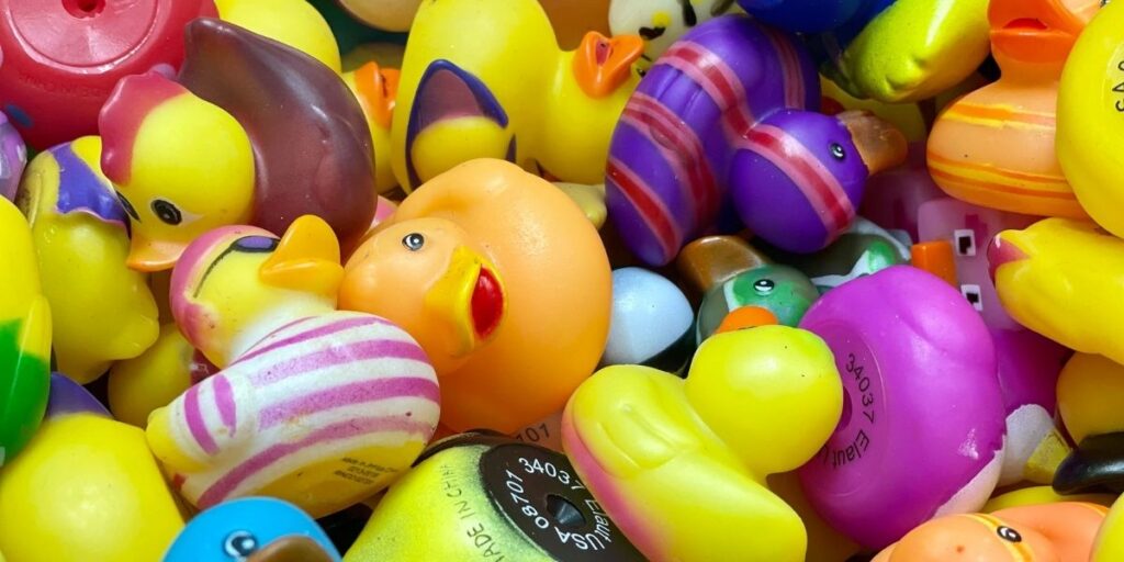 A photo of lots of rubber ducks in a big pile.