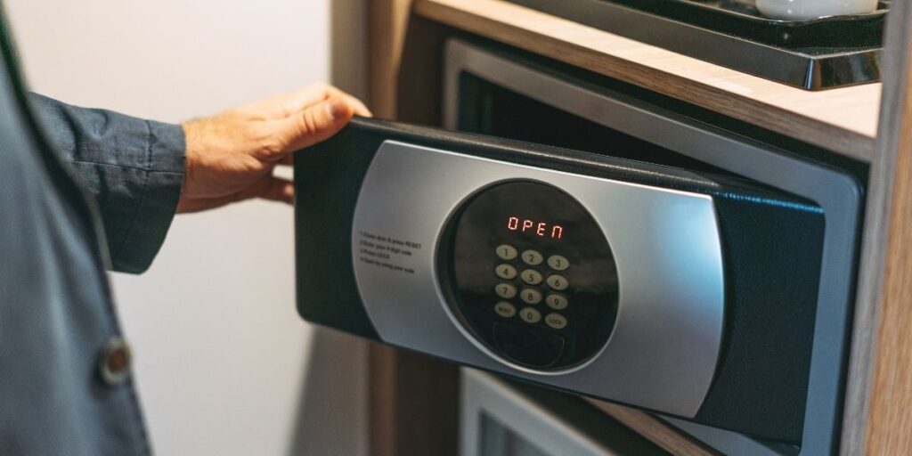 A hand opening a safe on a cruise ship