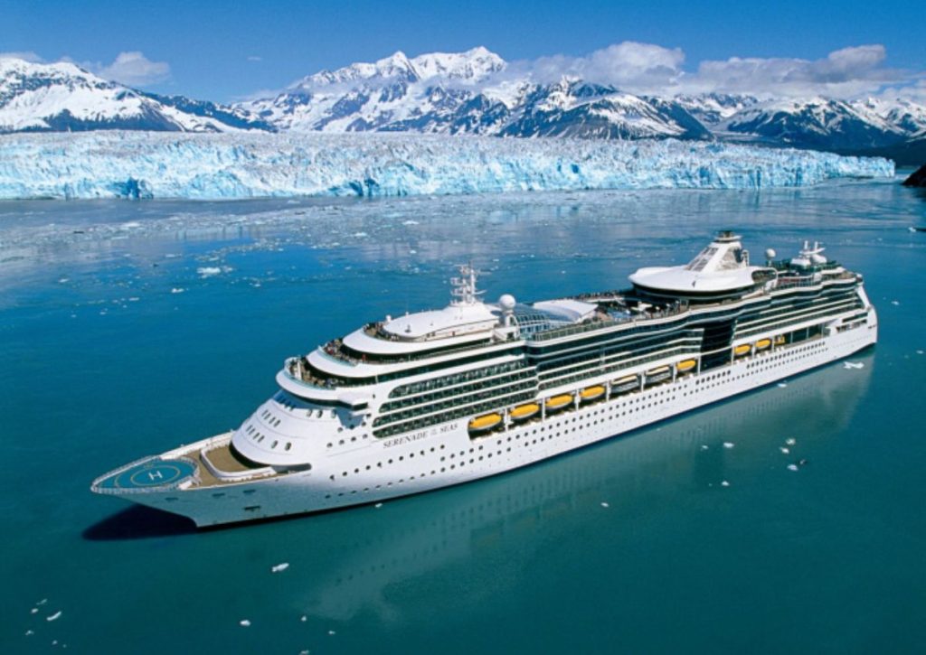 Royal Caribbean's Serenade of the Seas cruise ship amidst the awe-inspiring Alaskan landscape, with a vast glacier in the background and pristine icy waters reflecting the ship's elegant design.