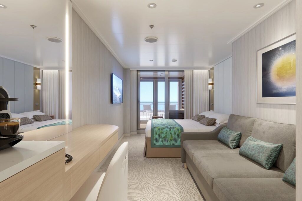This image displays a Mini Suite aboard the Sun Princess cruise ship, featuring a cozy yet stylishly appointed interior. The suite includes a comfortable seating area, a queen-sized bed with decorative accents, a flat-screen TV, and a private balcony offering scenic ocean views. The neutral color scheme with soft teal highlights creates a calm and inviting atmosphere for a relaxing onboard experience.