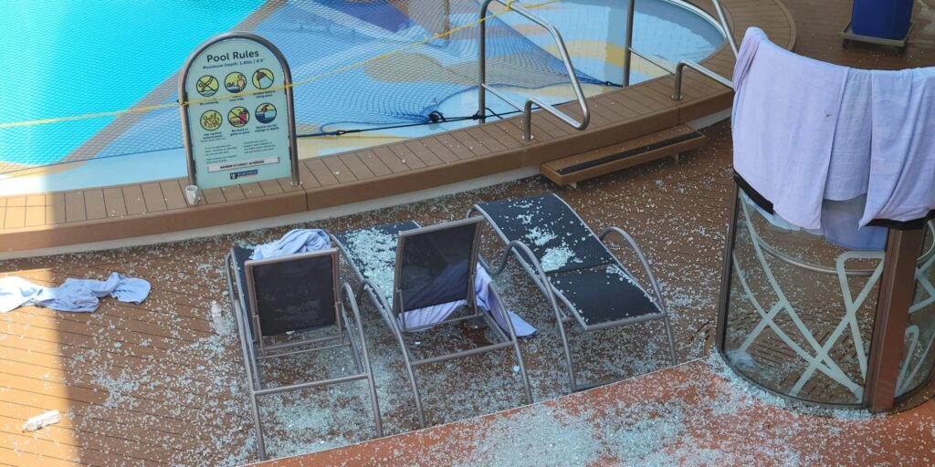 Smashed glass covering 3 sunbeds on Royal Caribbean's Symphony of the Seas cruise ship.