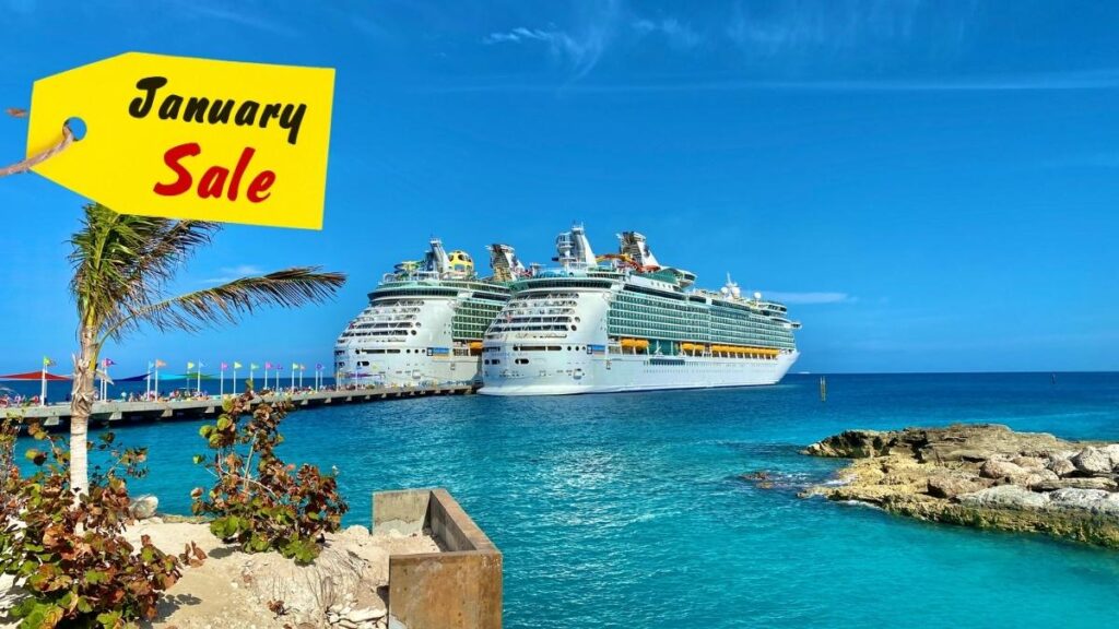 Two large cruise ships docked at a sunny, tropical port with turquoise waters and a rocky shoreline. A yellow tag in the top-left corner reads 'January Sale' in bold red and black text, promoting a seasonal travel deal.