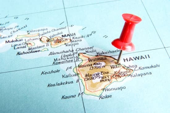 A close-up of a map of Hawaii with a red pushpin marking the islands.