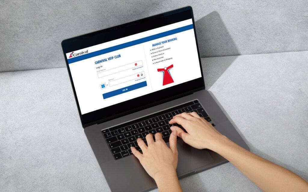 A person's hands are shown typing on a laptop that displays the Carnival Cruise Line online check-in page, indicating a user engaging with the Carnival VIFP Club's website to manage their booking.