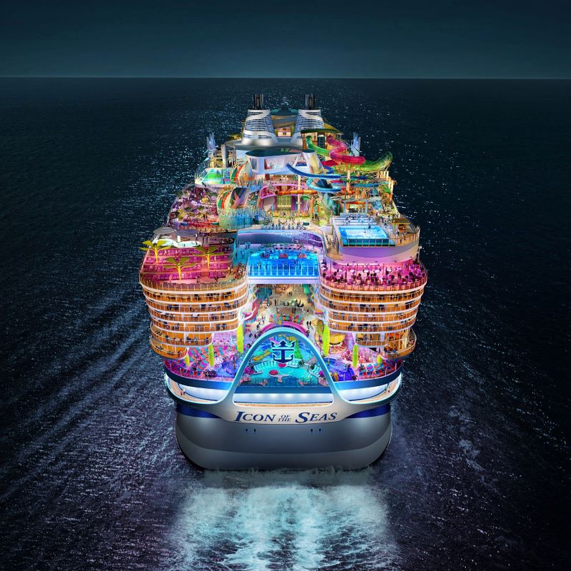 Royal Caribbean's Icon of the Seas cruise ship, illuminated at night showcasing its colorful, bustling decks with a variety of entertainment options set against the dark ocean.