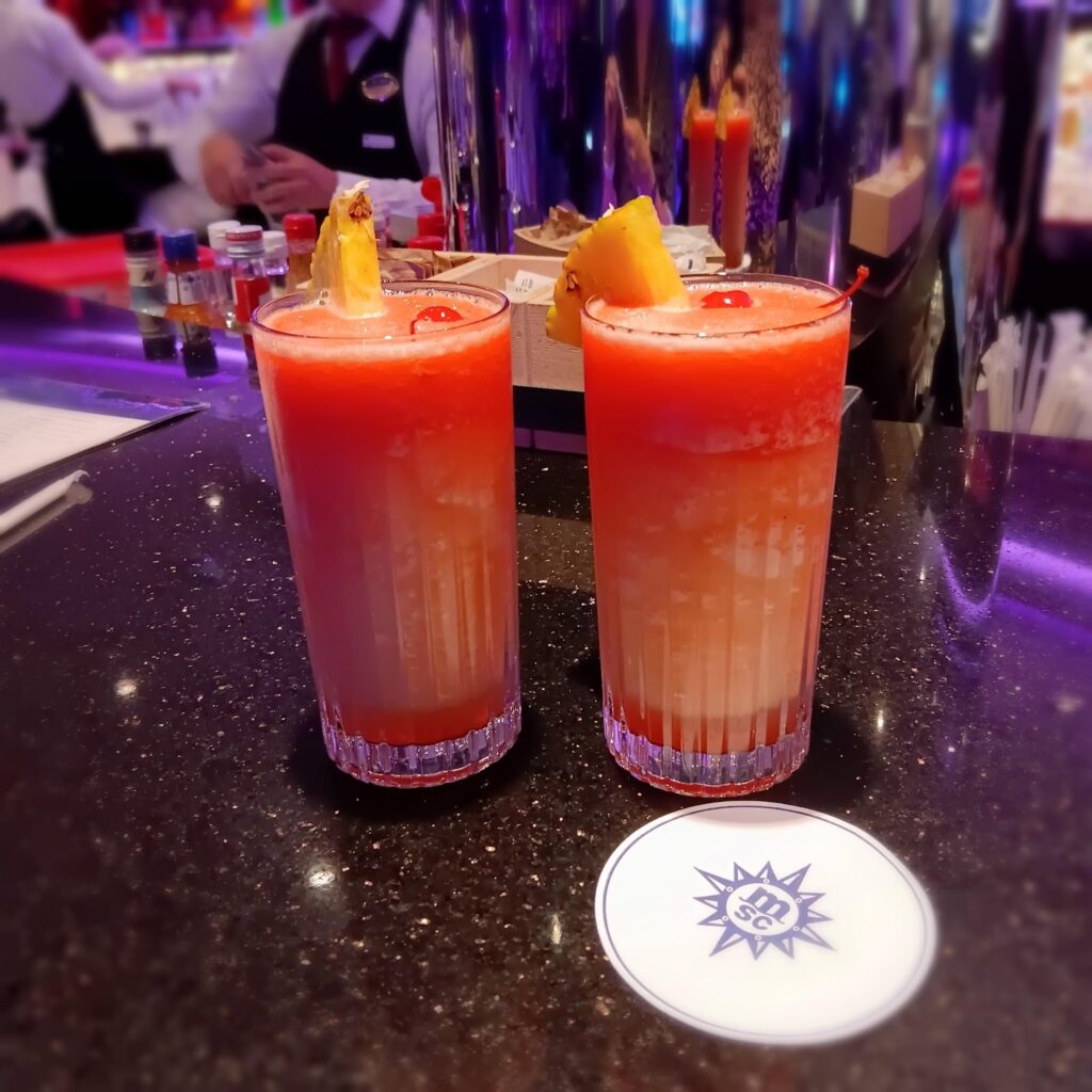 Appetizing orange cocktail with a slice of citrus fruit on the lip of the glass. 