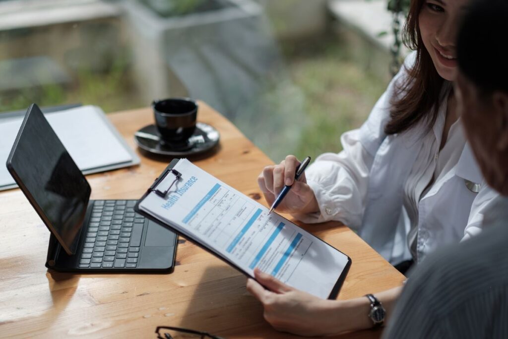 Insurance broker sealing the deal with  a cruise passenger while planning a cruise trip