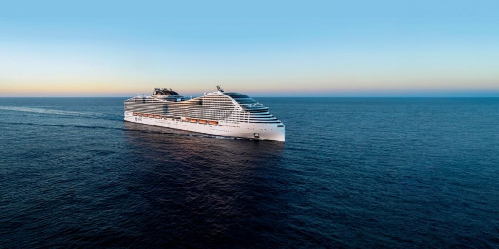 An MSC CRUISES cruise ship gliding through the ocean as the sun sets, casting a golden glow on the water.