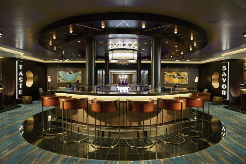 The sophisticated Mixx Bar on Norwegian Bliss, positioned between the Taste and Savor restaurants, with stylish bar stools and a sleek, modern design, creating an inviting atmosphere for cocktails and conversation.