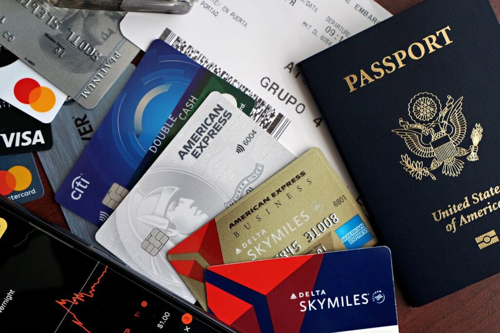 U.S. passport and boarding pass surrounded by credit cards and travel documents on a tabletop.