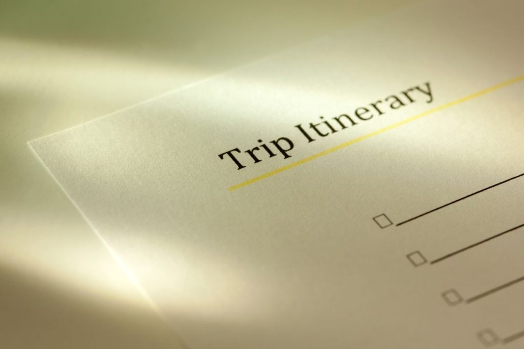 Close-up of a 'Trip Itinerary' document bathed in soft light, with checkboxes waiting to be filled, evoking the excitement and preparation of travel planning.
